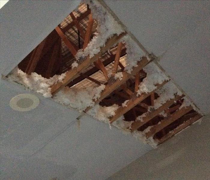 Hole in ceiling with obvious water damage