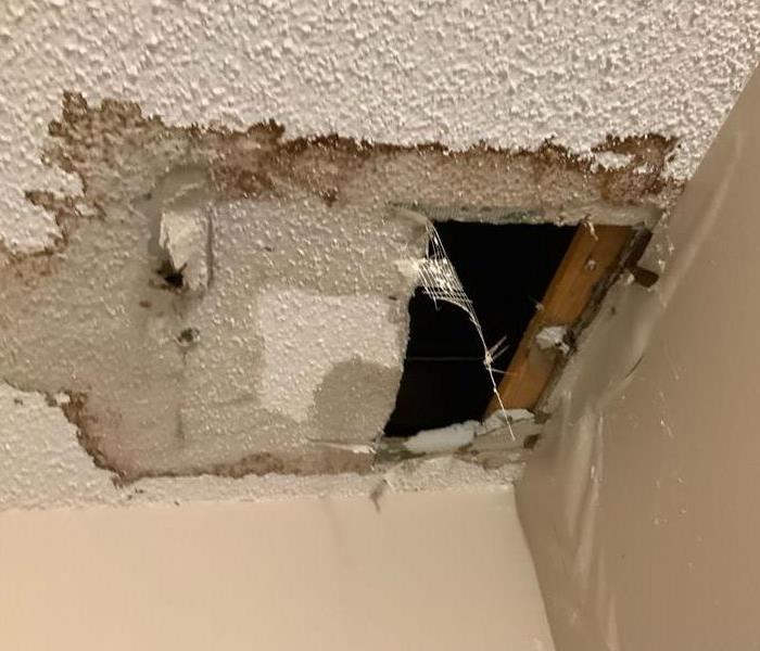 Water Damage with hole in ceiling